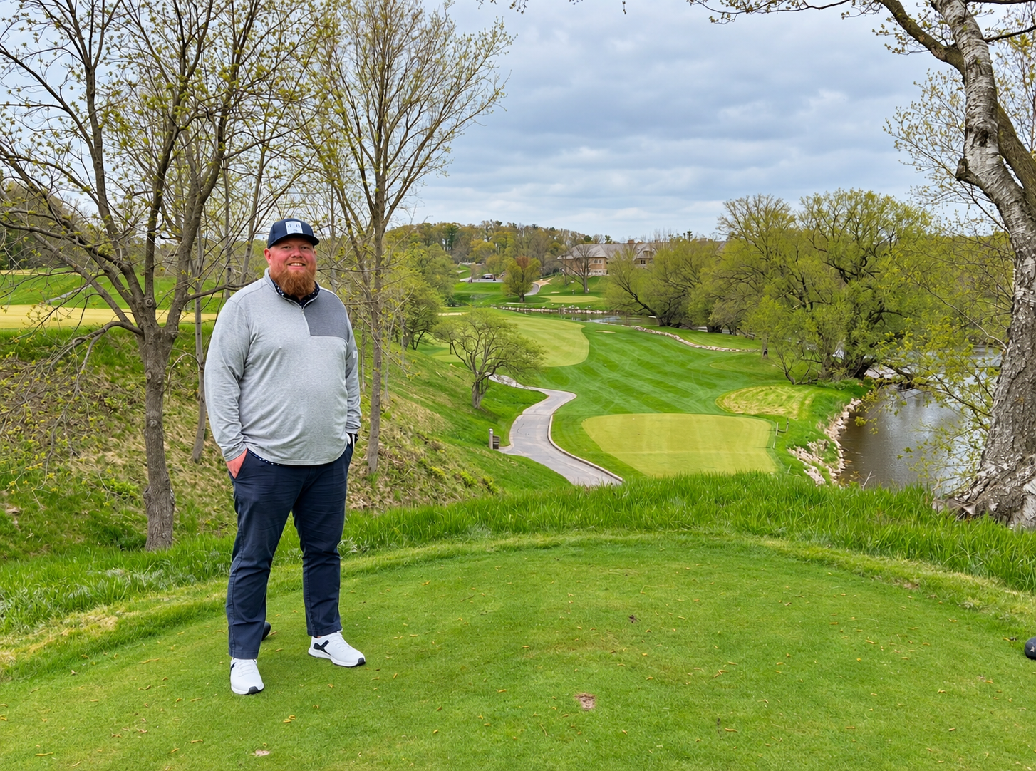 Ryan McCullough standing beside a golf course